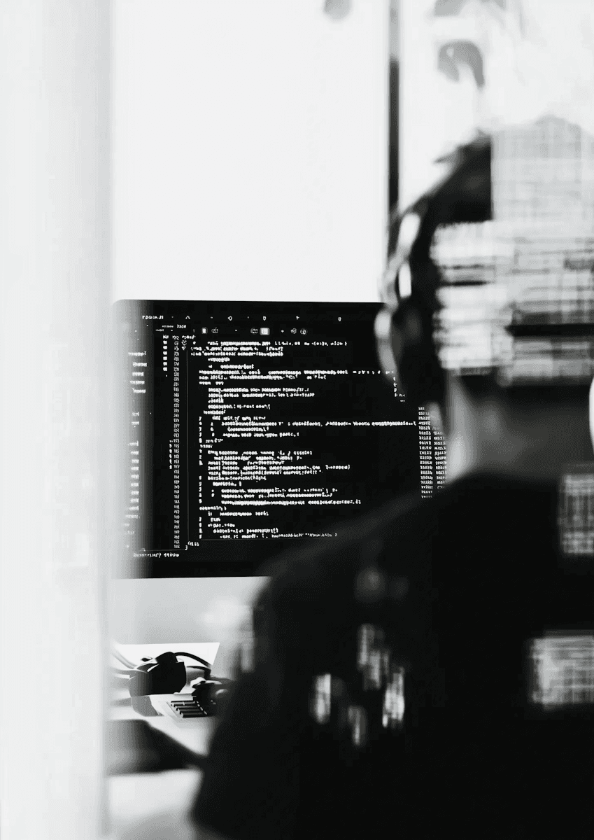 a man sitting at a desk in front of a computer