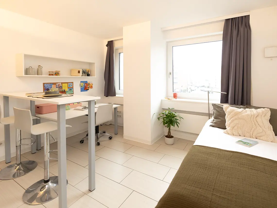 Bright private student studio in Frankfurt with bed, study area and modern living space