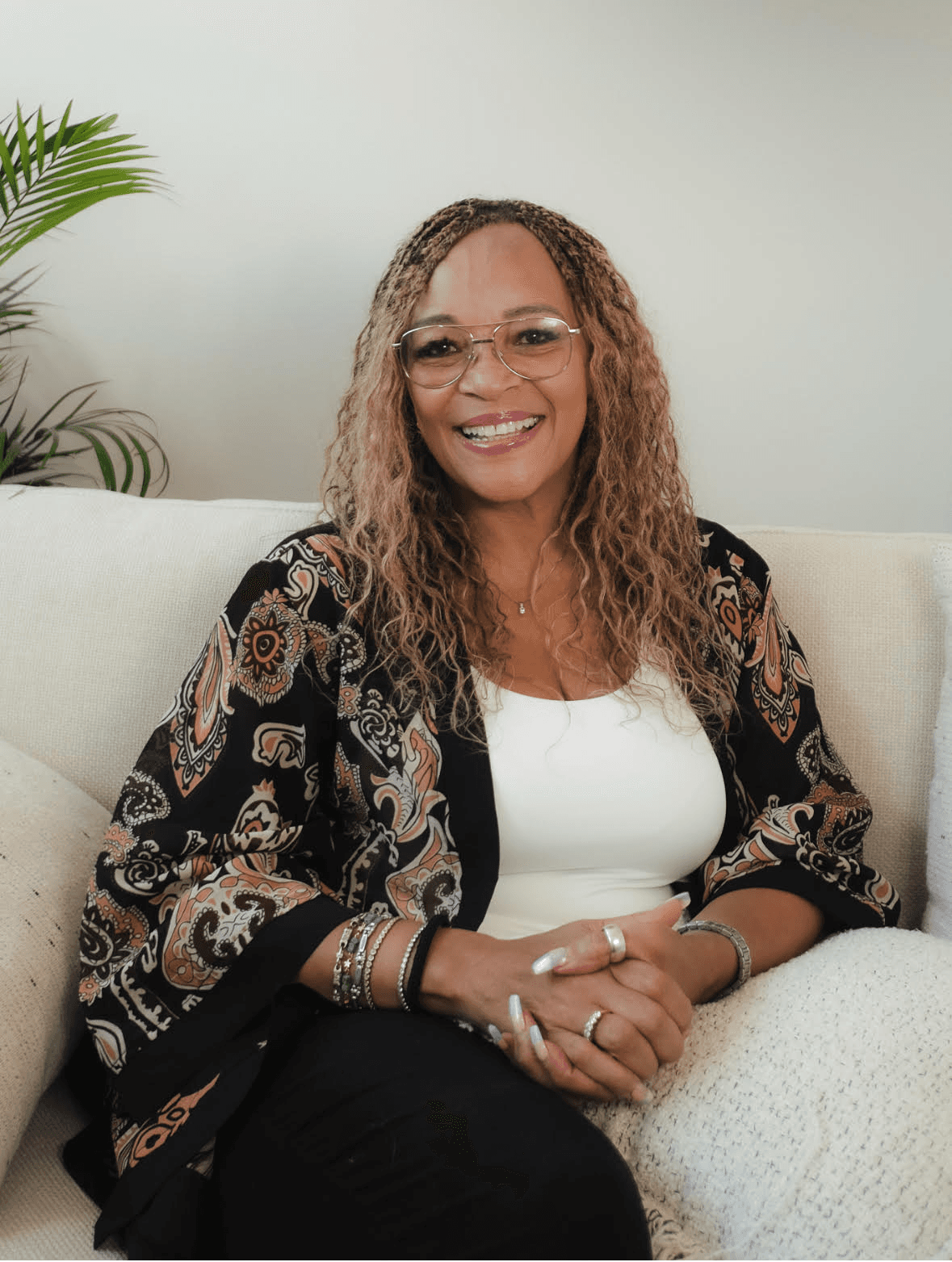 village near cliff and body of water under white clouds