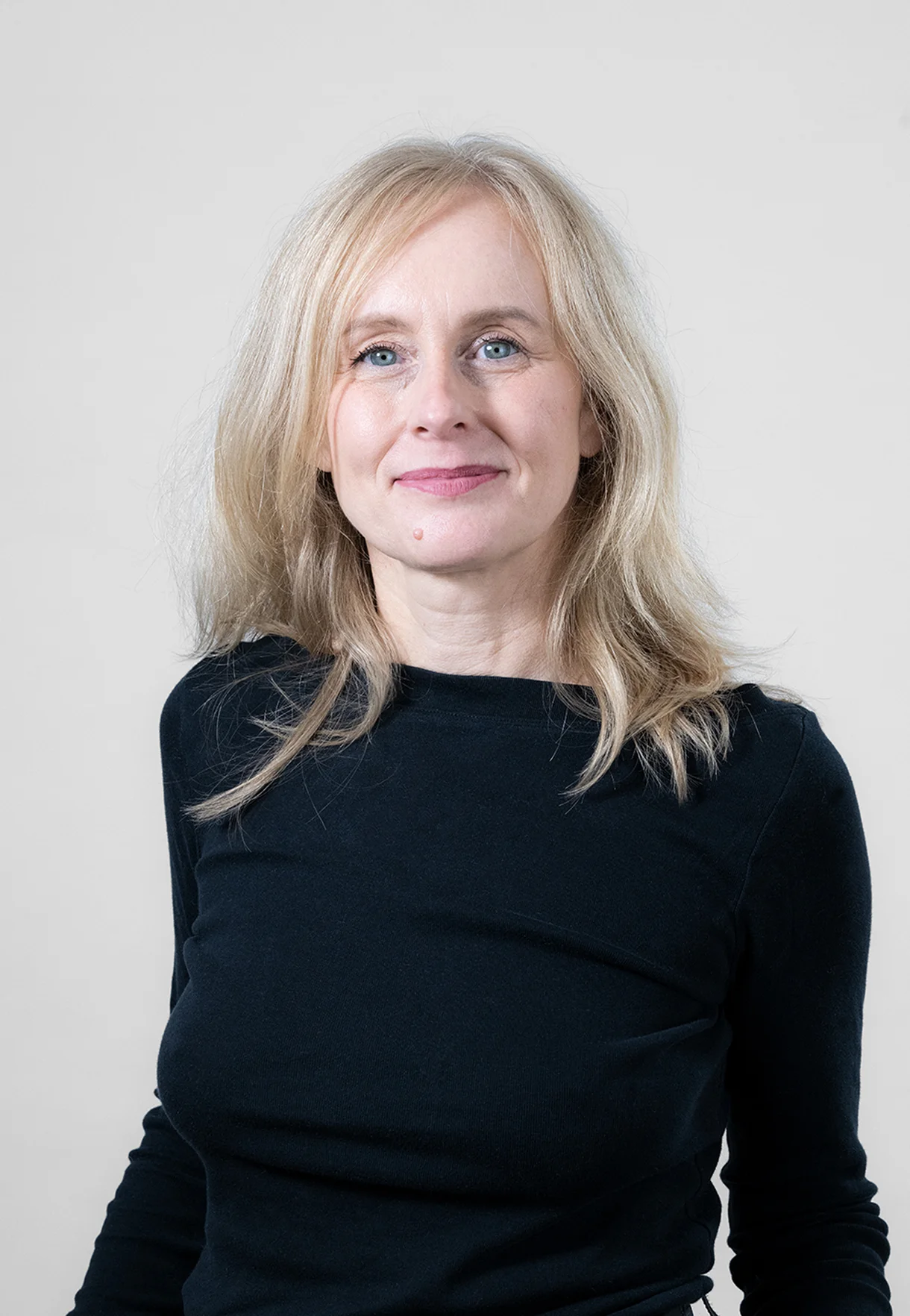 A woman receives a relaxing energy healing in a serene setting with soft lighting.