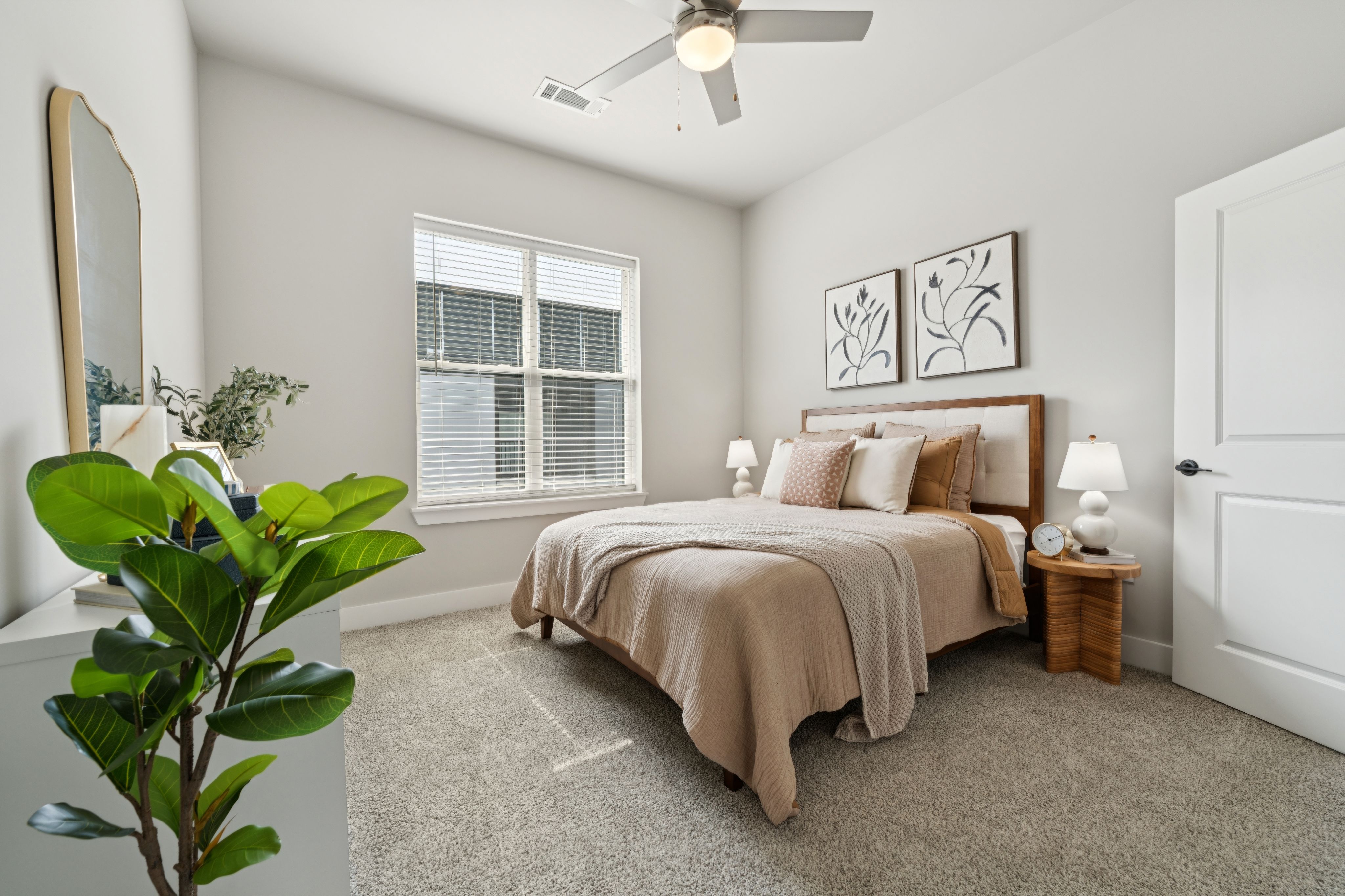 A cozy bedroom featuring a bed, a dresser, and a window allowing natural light to enter the space.