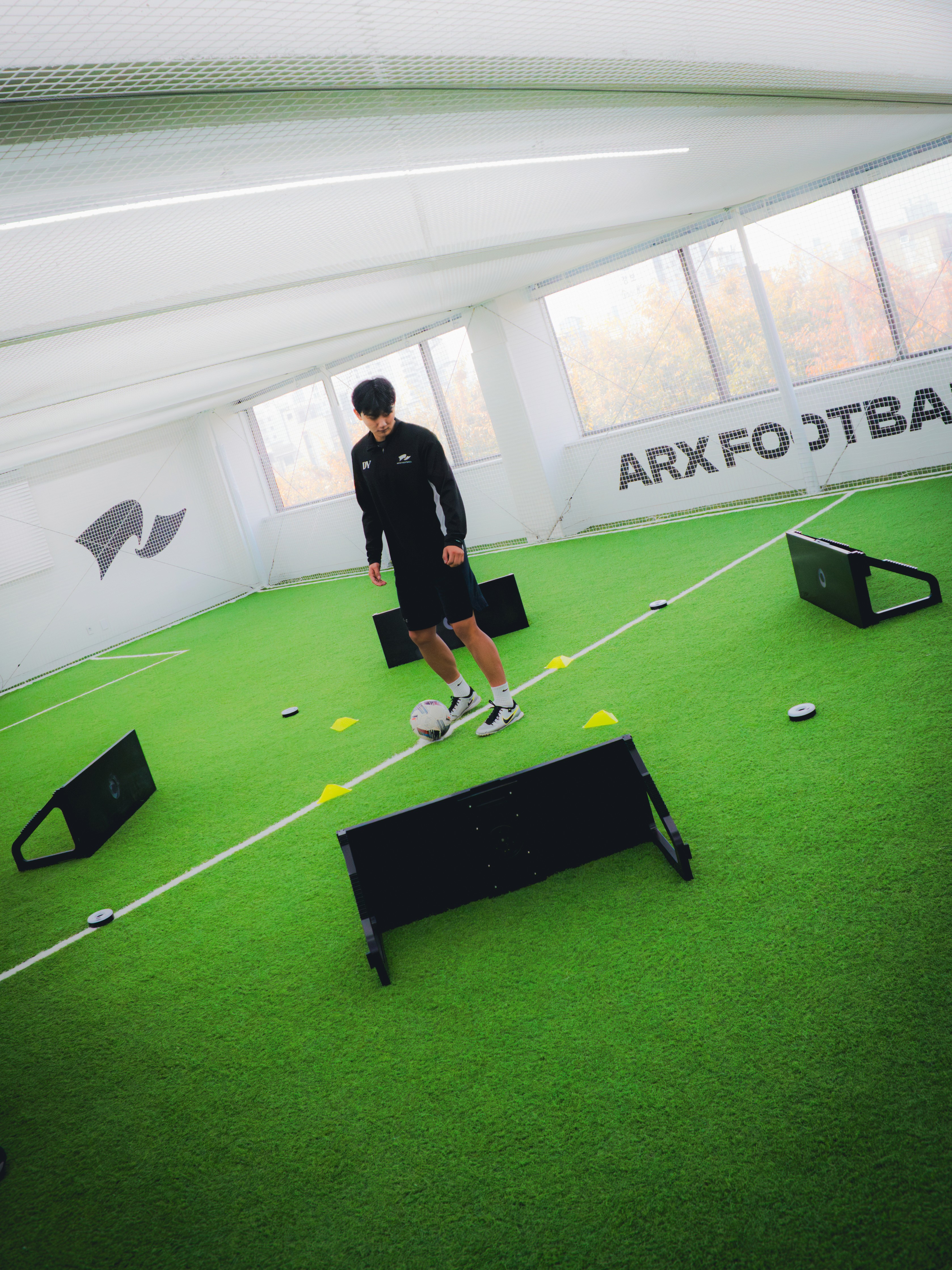 a person's feet with a ball on a purple carpet