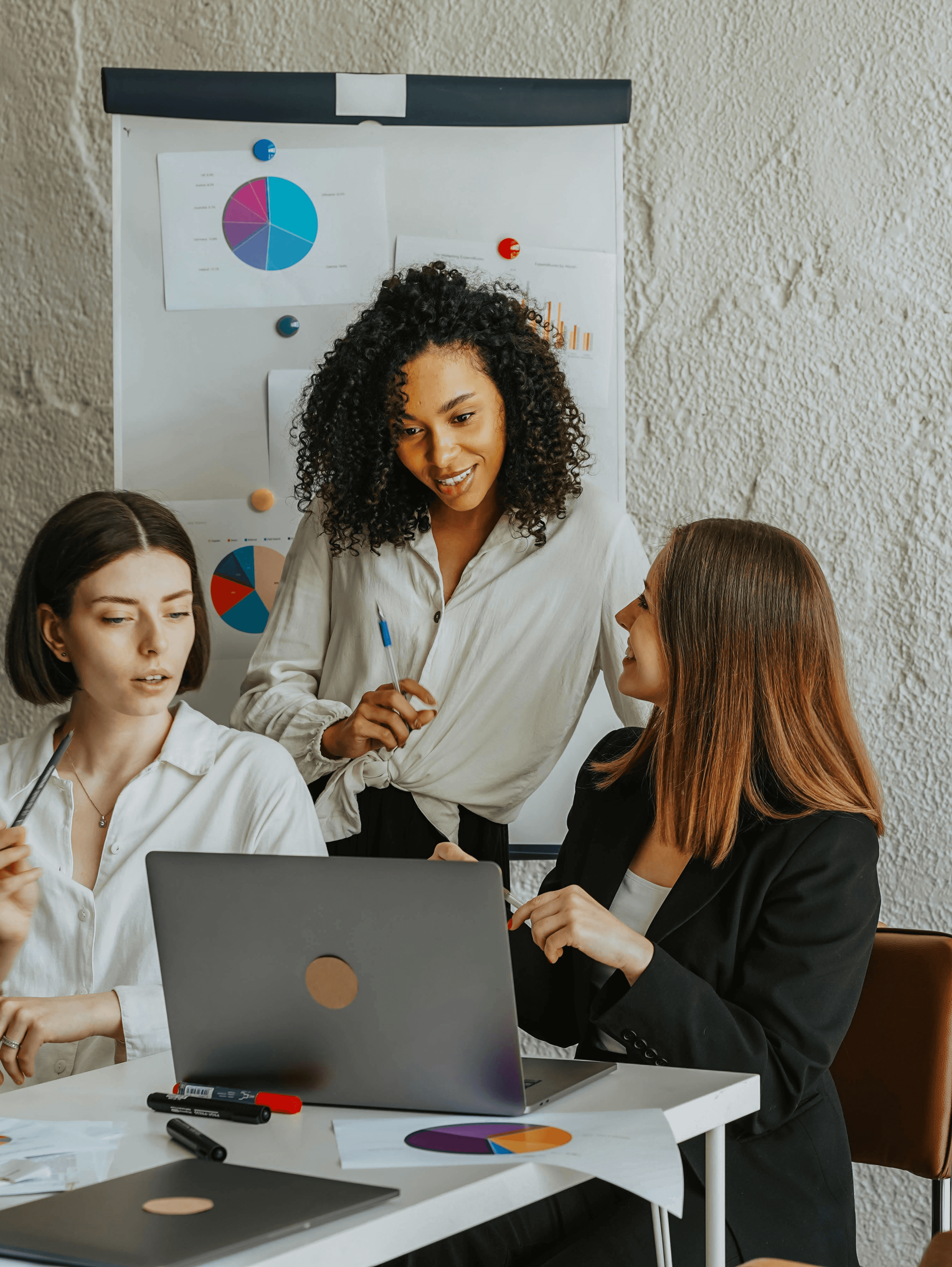 two ladies looking at a laptop and smiling