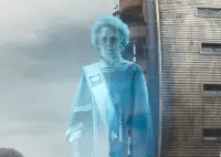 A blue hologram of a woman in a town square