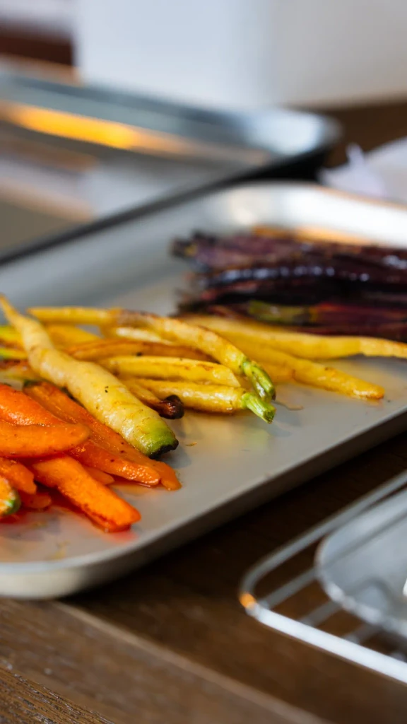 Roasted heritage baby carrots in orange, yellow and purple