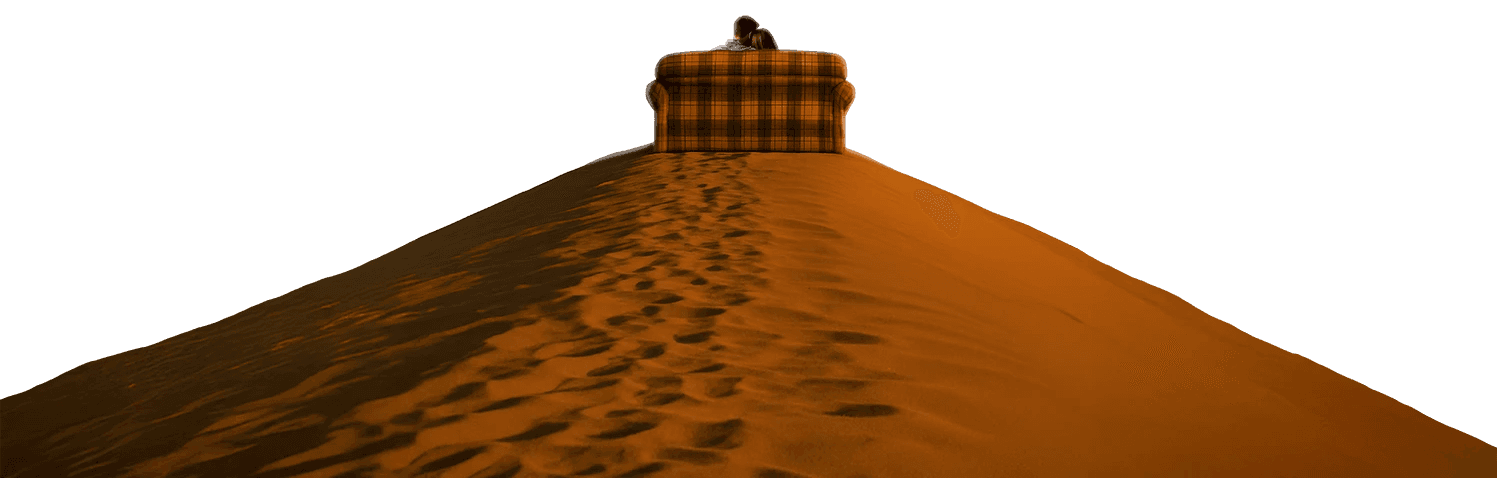 A couple sits on a couch on top of a dune