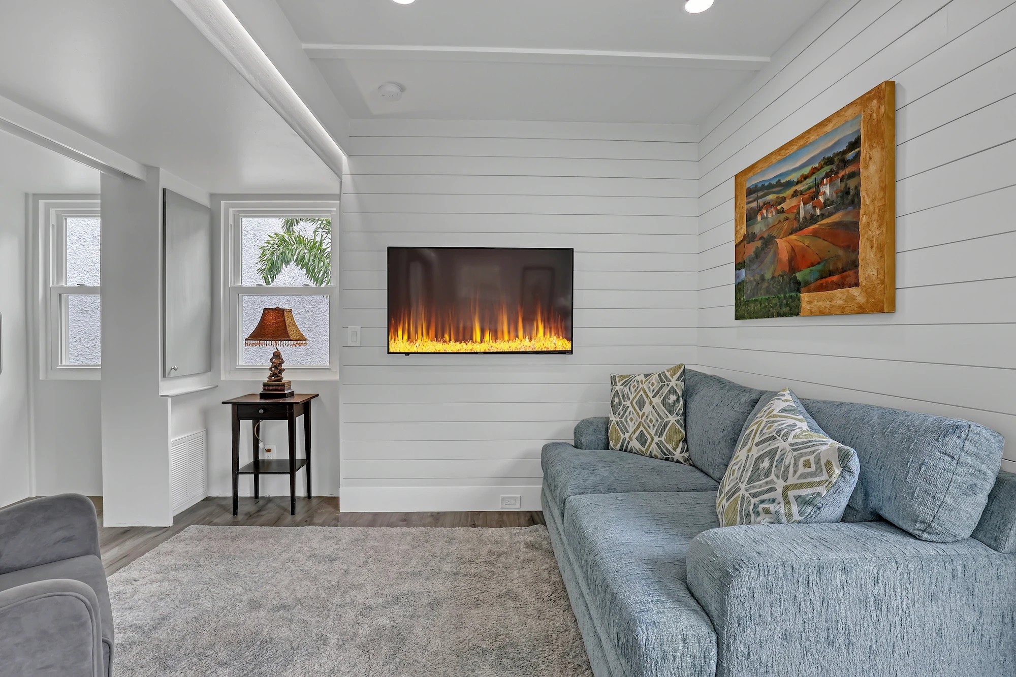 Mesocore Model E ADU interior living room with electric fireplace and shiplap walls