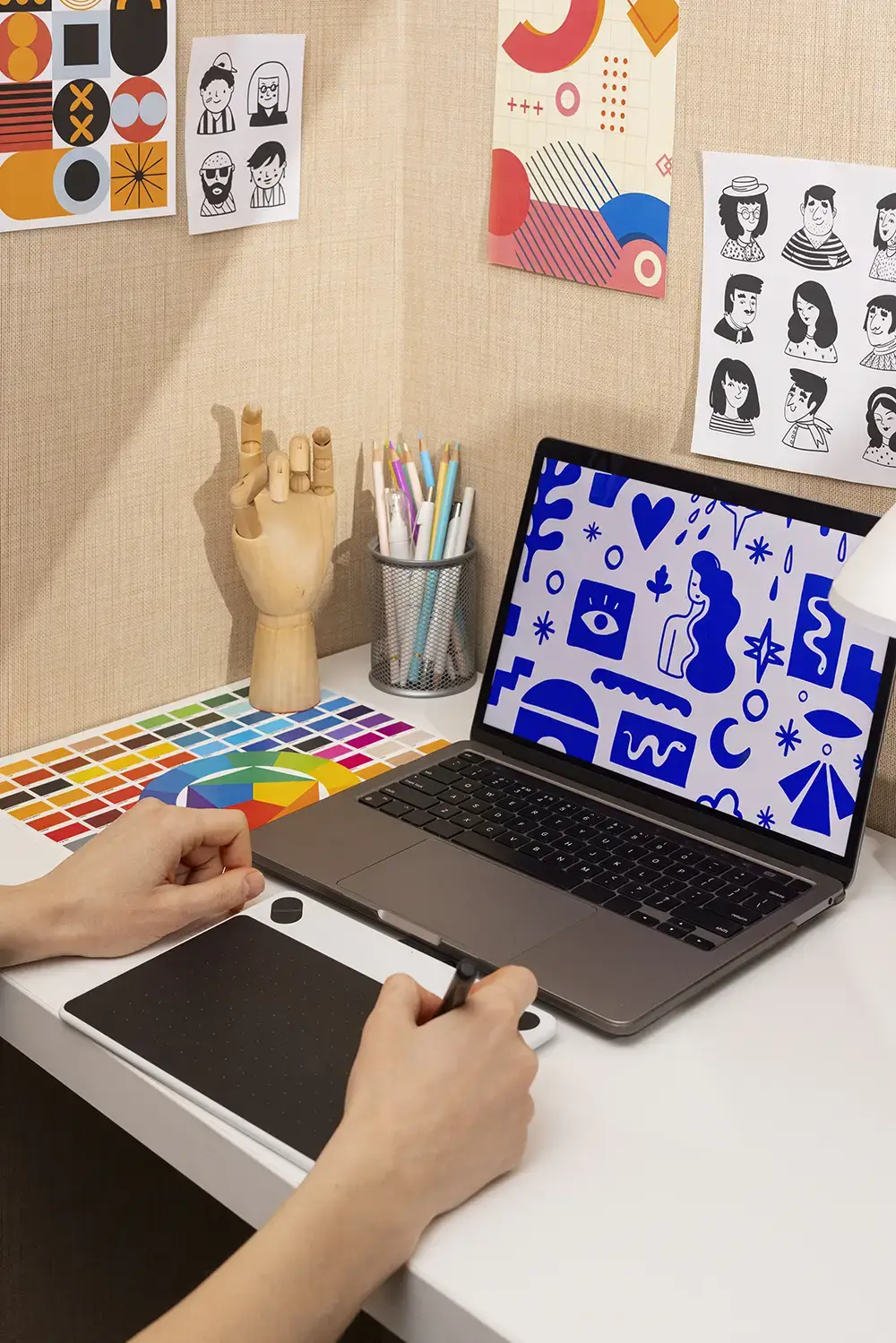 A graphic designer is at work creating visuals logos colors and illustrations