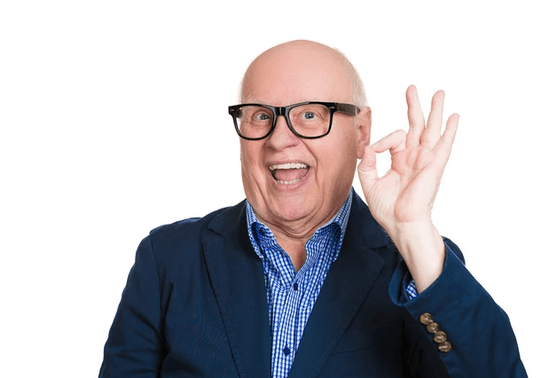A person in glasses and a blue jacket pointing.