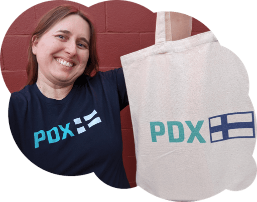 Person wearing PDX Finn Shirt and holding up the PDX Finn tote bag