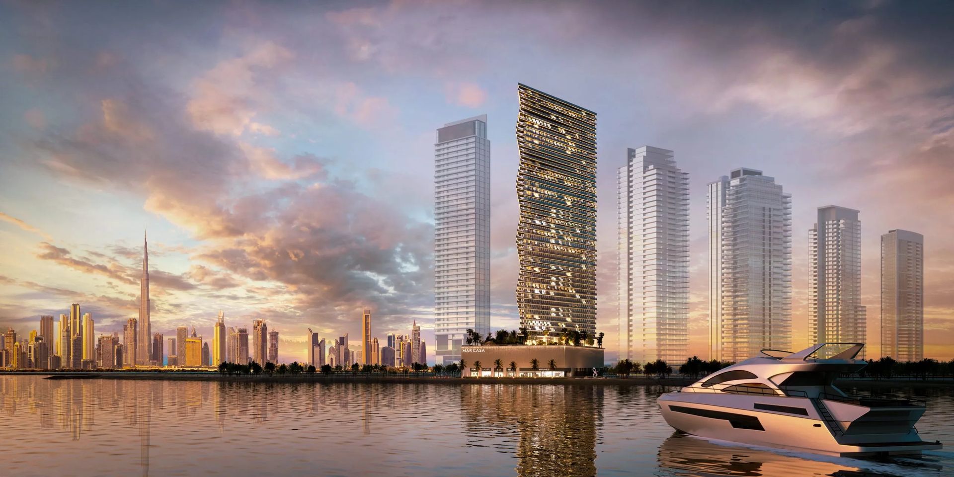 Panoramic image of Dubai Maritime City featuring sleek buildings and yachts in the marina against a clear blue sky.