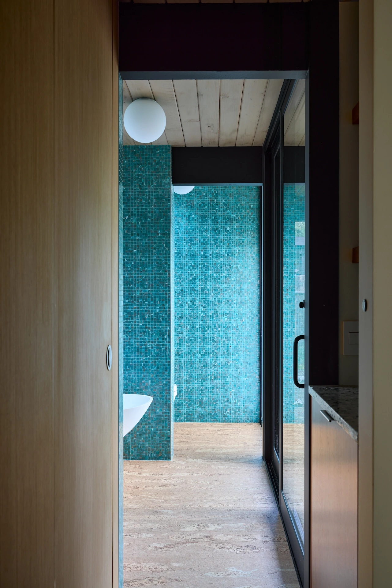 View of the master bath entry hallway in the Fairhills Eichler Tract home, showcasing a seamless transition into a space of modern luxury and comfort. Photo by Todd Huge.