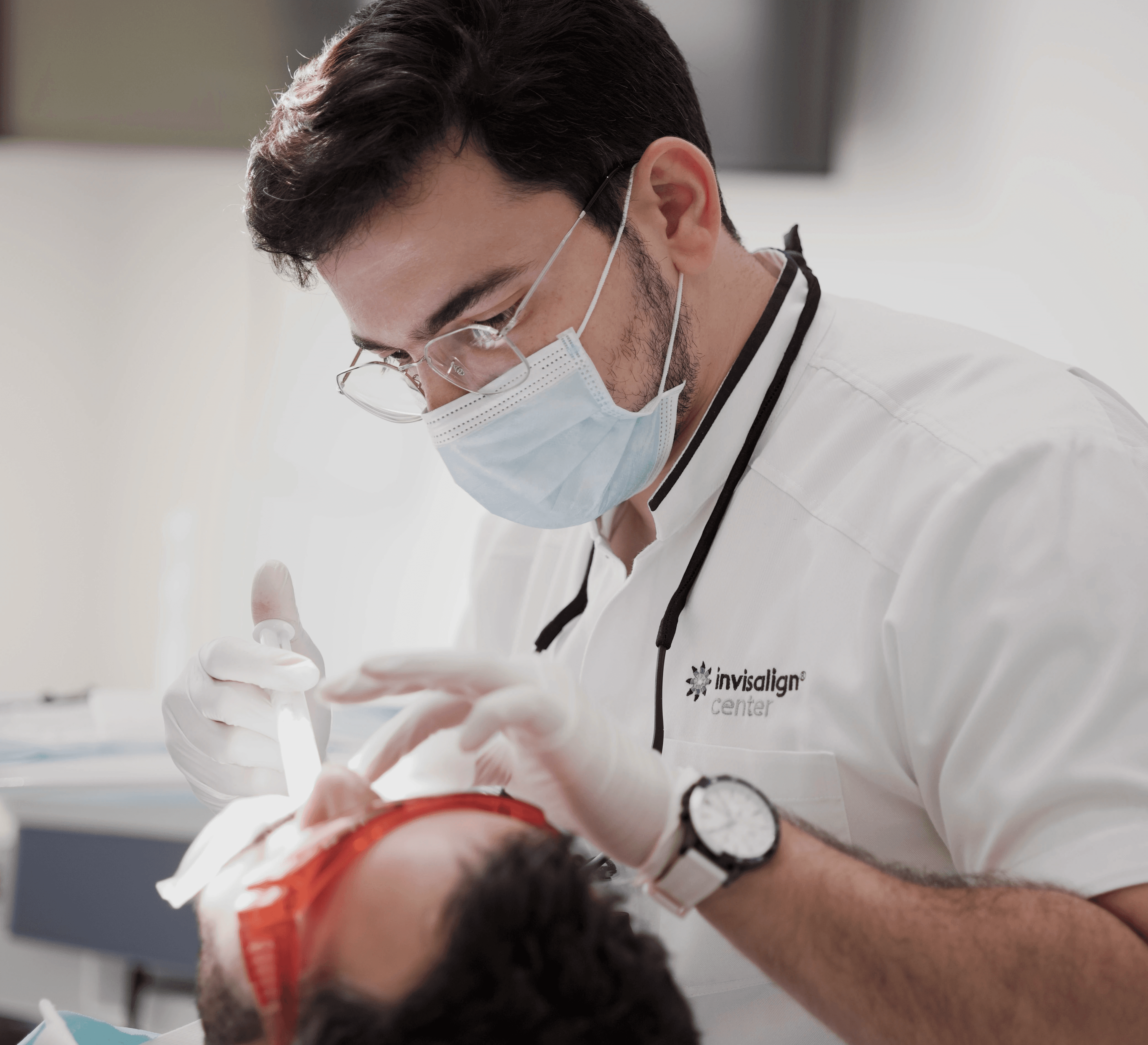 Dentist examining a patient to identify the cause of sensitive teeth