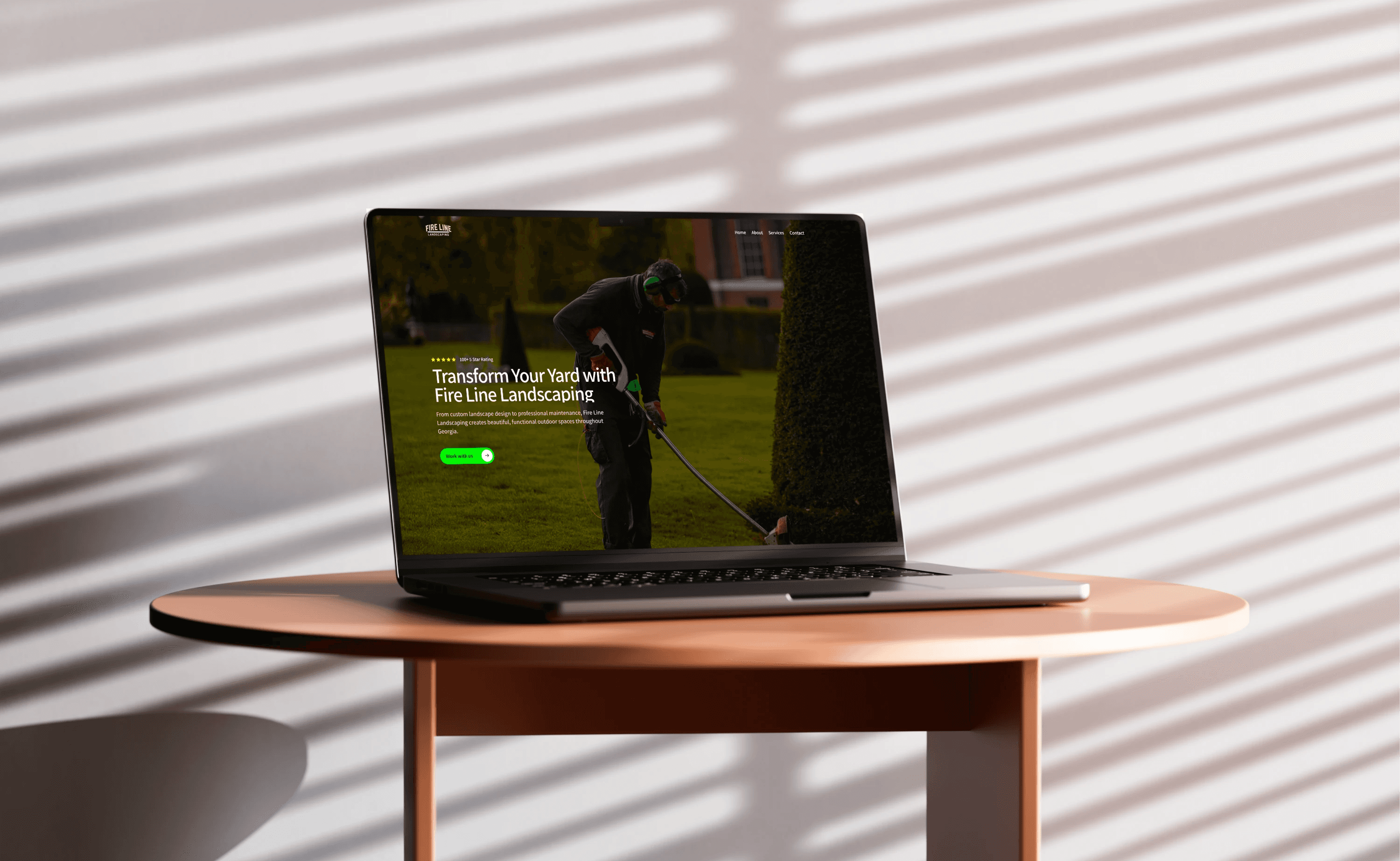 Fire Line Landscaping website shown on shiny laptop screen – professional landscaping and lawn care services