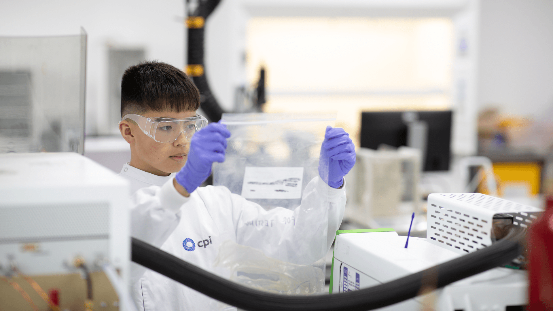CPI expert checking a plastic bag containing materials.