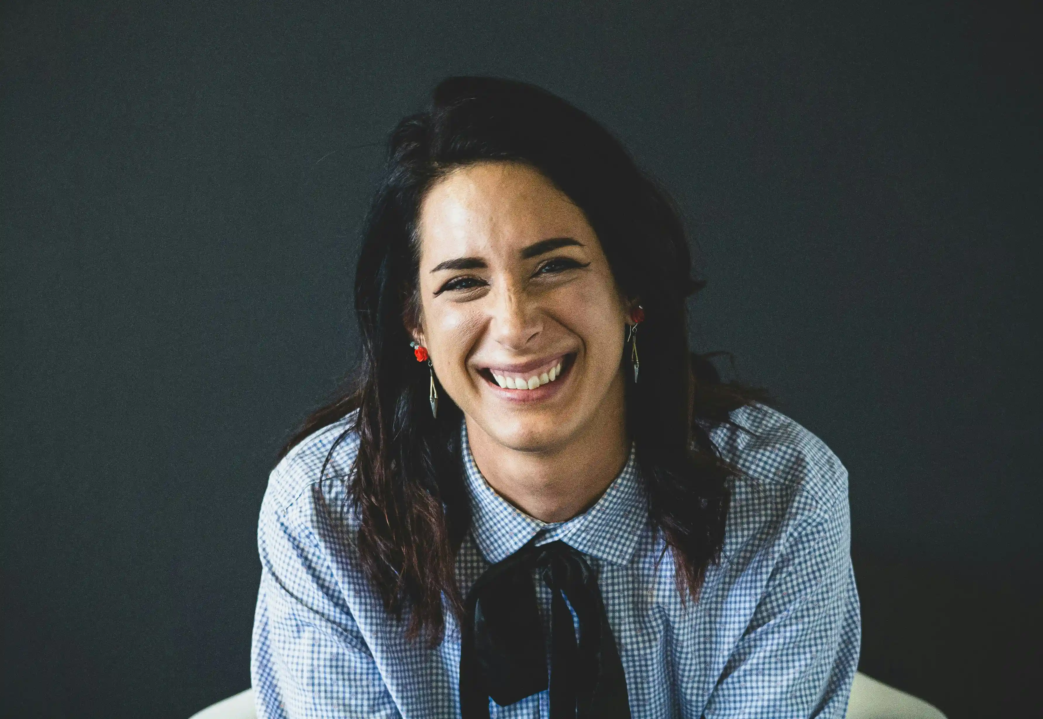 Portrait of a woman smiling and looking into camera.