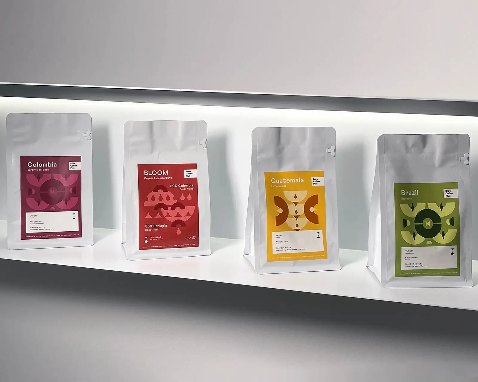 Shelf display of Brew Coffee Plus coffee bags with red, yellow, and green labels