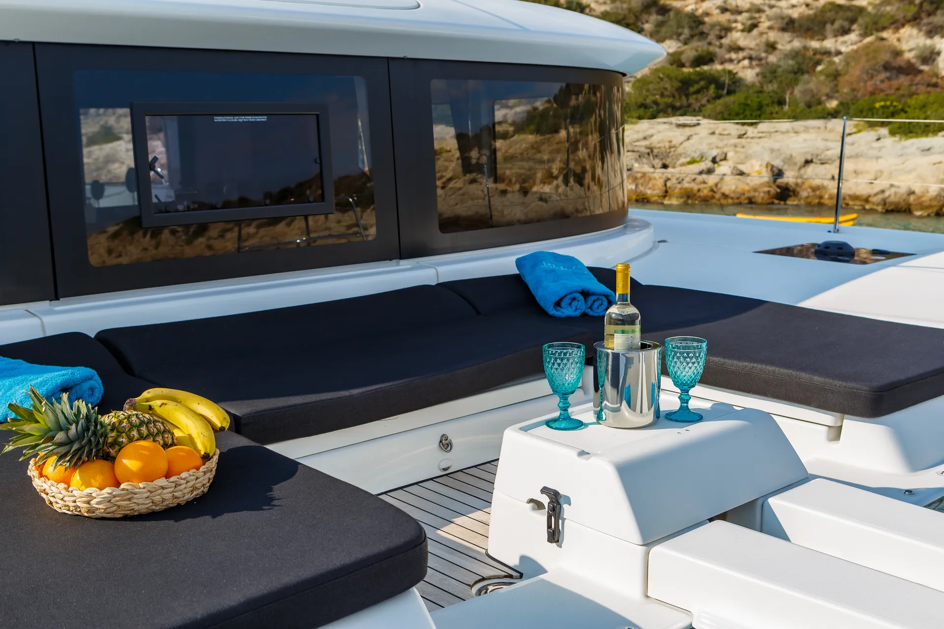 White Rock 36 speedboat with captain at helm cruising calm blue waters near Paros coastline with hills in background.