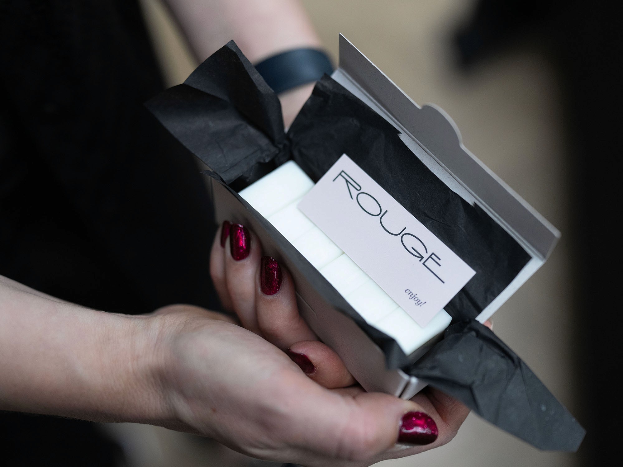 hands holding an open box of wax melts