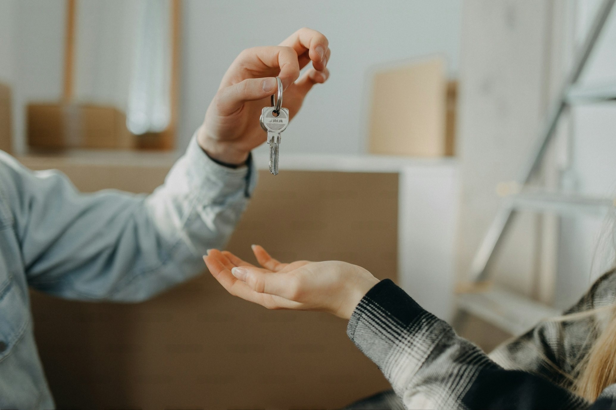 a-happy-young-couple-buying-their-new-home-and-receiving-keys-from-real-estate-agent