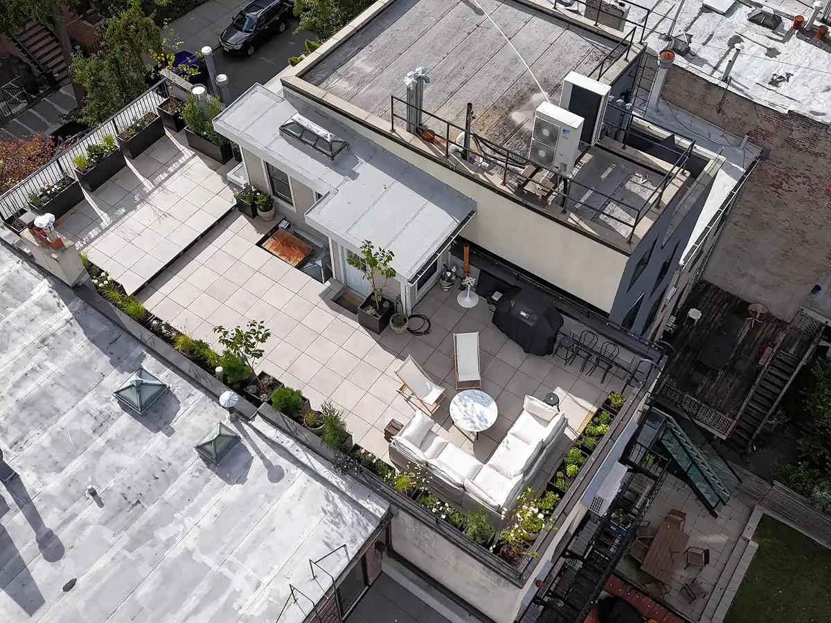 Custom TileTech Cenere-Cement pavers rooftop deck on Hybrid Pedestal base with planters, seating lounge, and grill in Park Slope, Brooklyn, NYC
