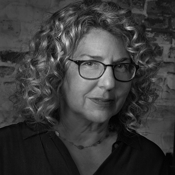 a black and white photo of a woman wearing glasses