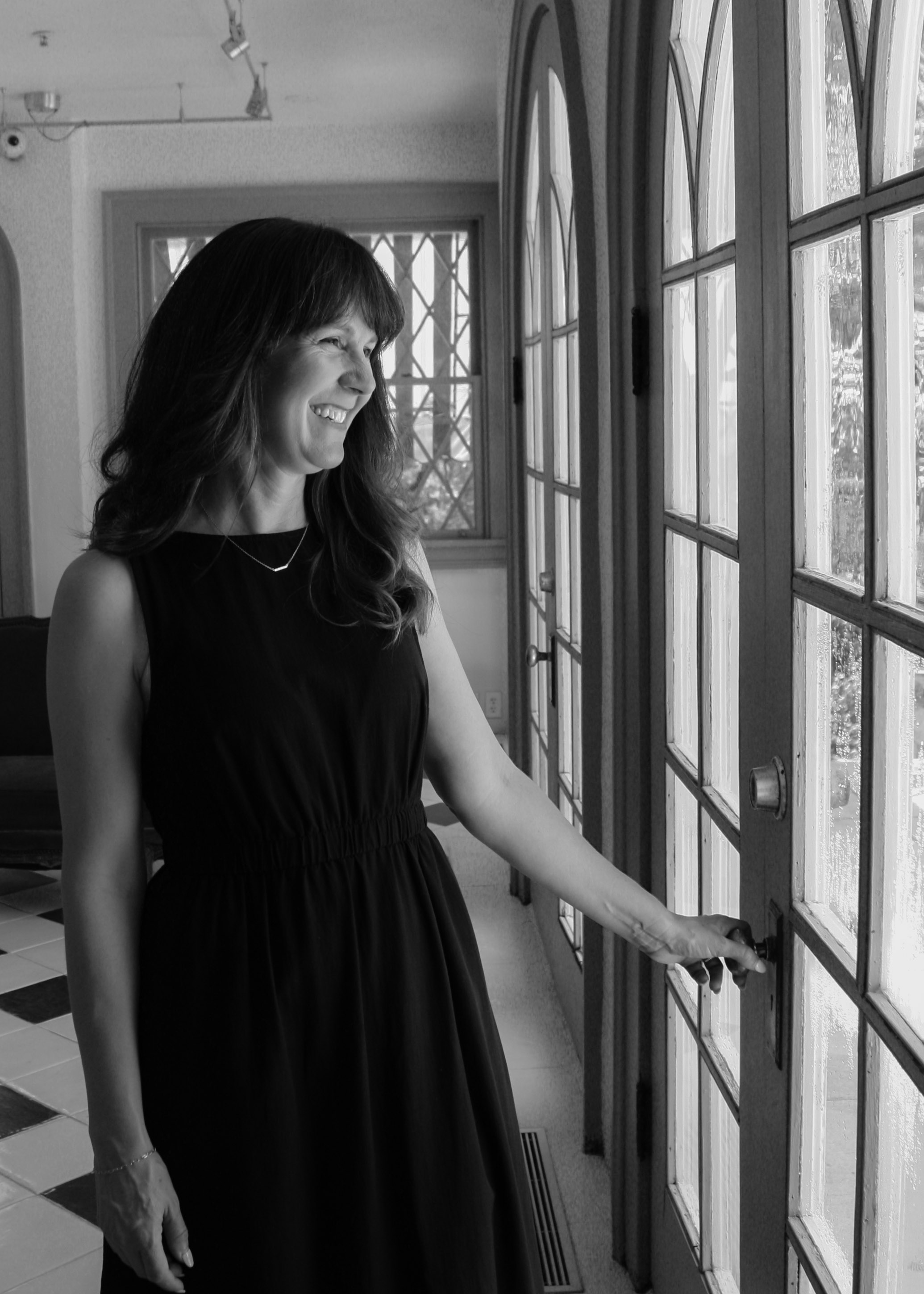 Floral summer dress on a wooden hanger by a window