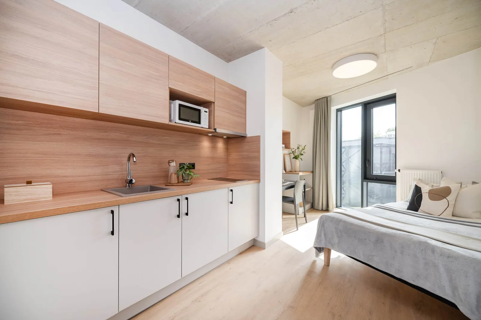 Private student studio in Riga with fitted kitchenette, bed and bright living space