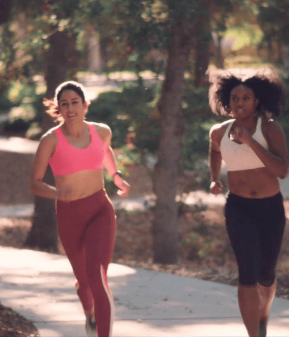 Two women running outdoors wearing Brooks Run Bras, showcasing authentic performance and confident storytelling in brand video.