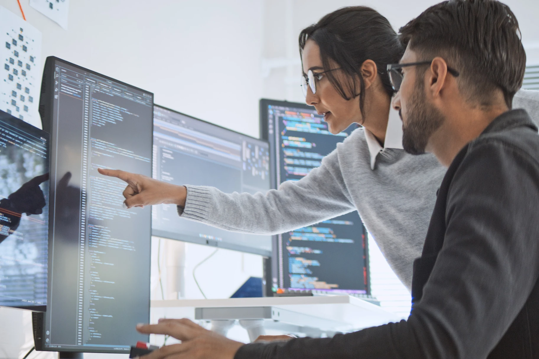 Professional man and woman in office with laptop