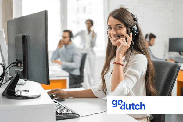 Image of a young woman wearing a headset supporting clients of GoDutch via the telephone