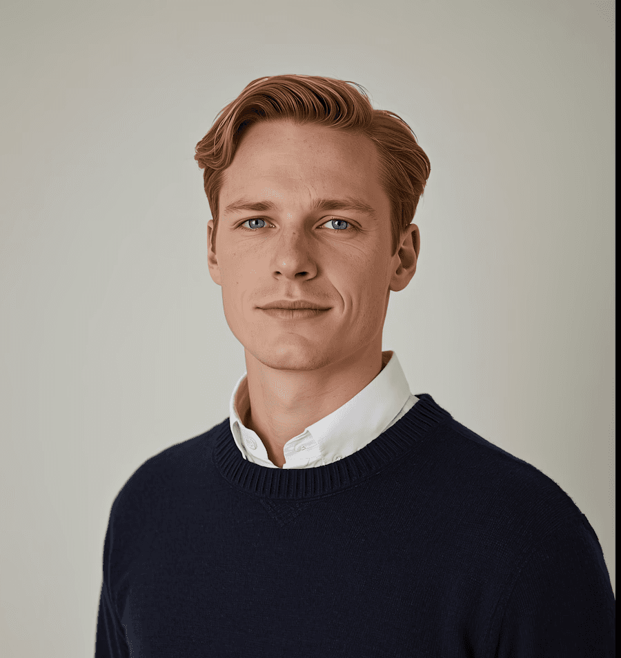 Young professional man with auburn hair in navy sweater, CEO of Carstensz