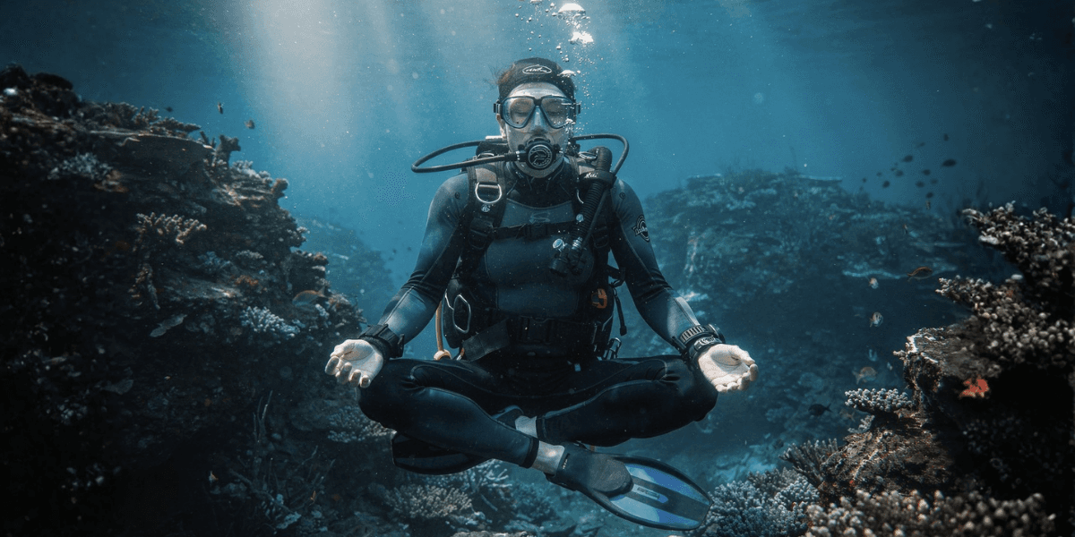 Dr. Calina Ouliaris, co-founder of Journey Underwater, integrates mindfulness with scuba diving, offering transformative wellness experiences through the Dive In™ framework.