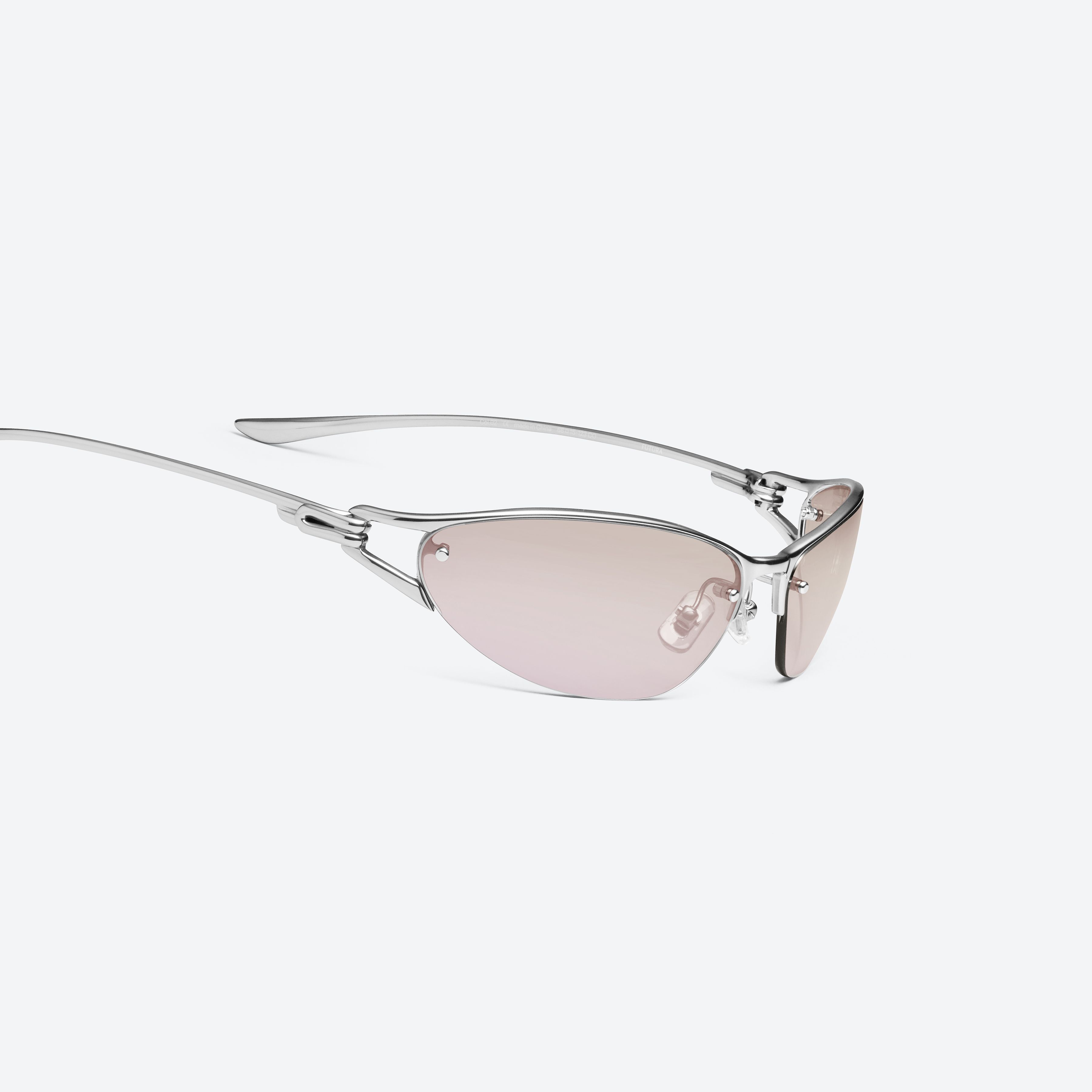 Détail à 45 degrés des lunettes enveloppantes Pinku 01, monture métal argenté.