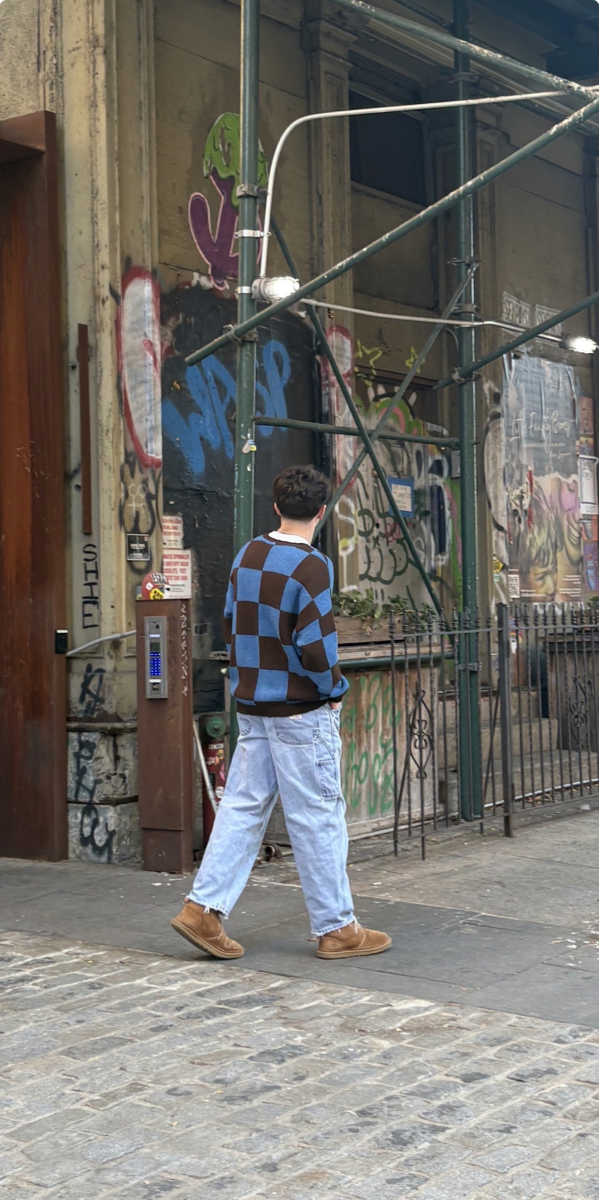 a blurry photo of a person standing in front of a wall