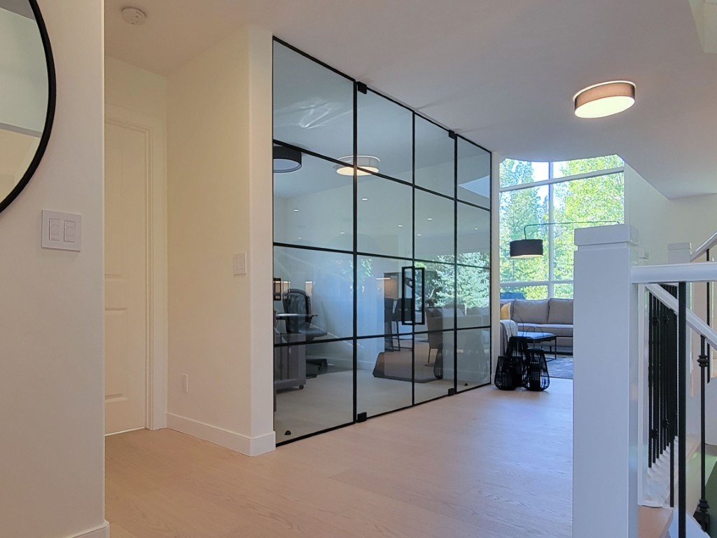 Image of Modern interior design with glass partition, staircase, and luxury home features by KHD Homes design-build.