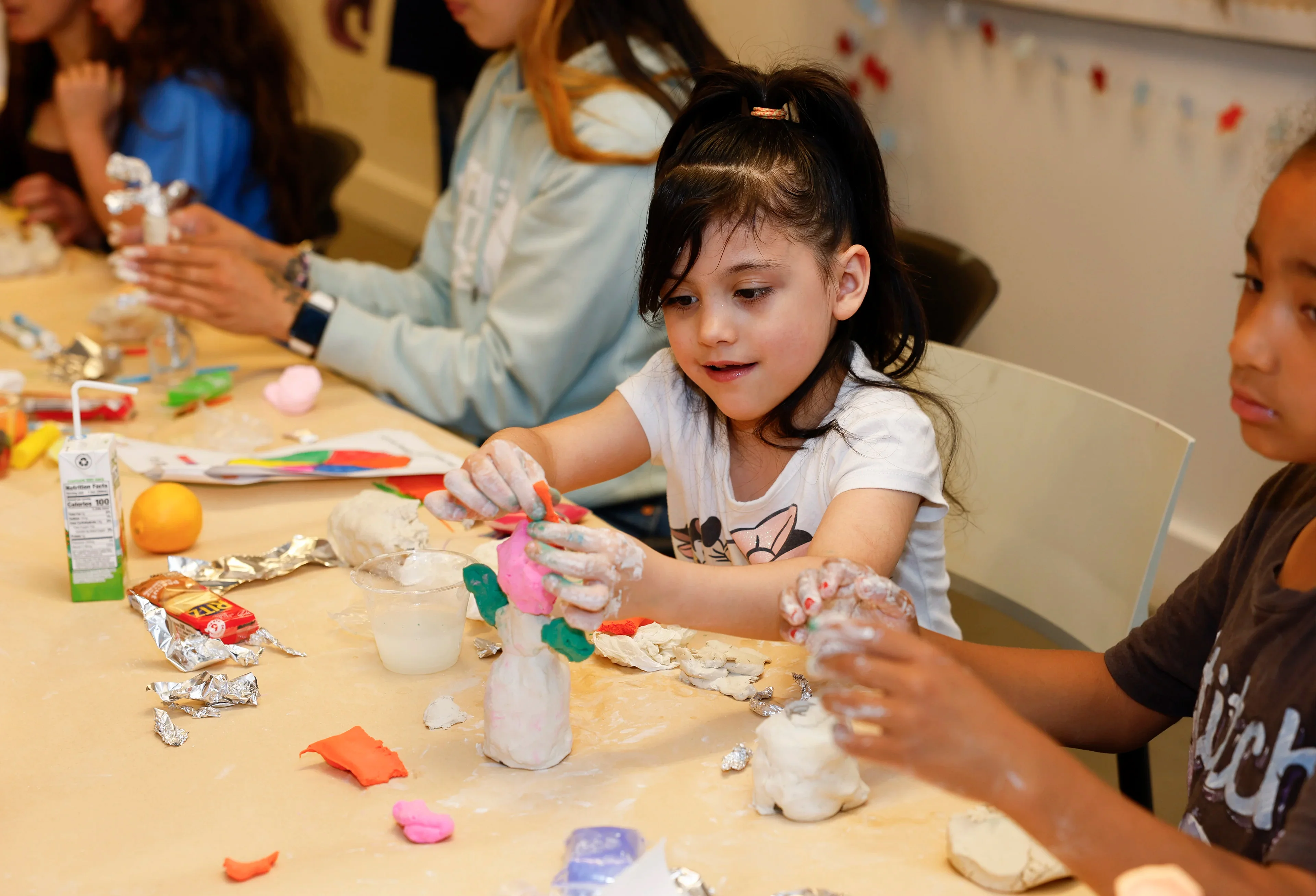 Children working with clay in an art event
