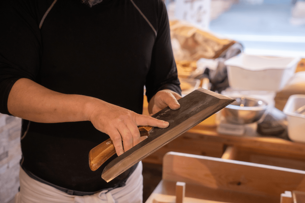 Chef holding a specialty soba cutting knife