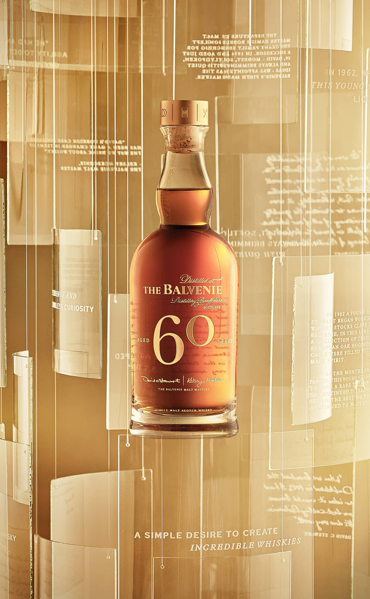 A bottle of whiskey against a blurred, warm-toned background with geometric shapes.