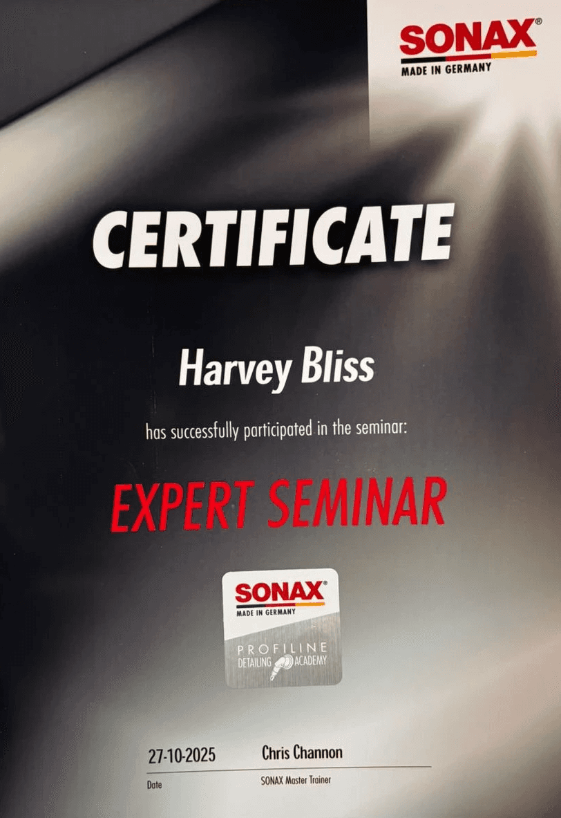 a man waxing the hood of a car