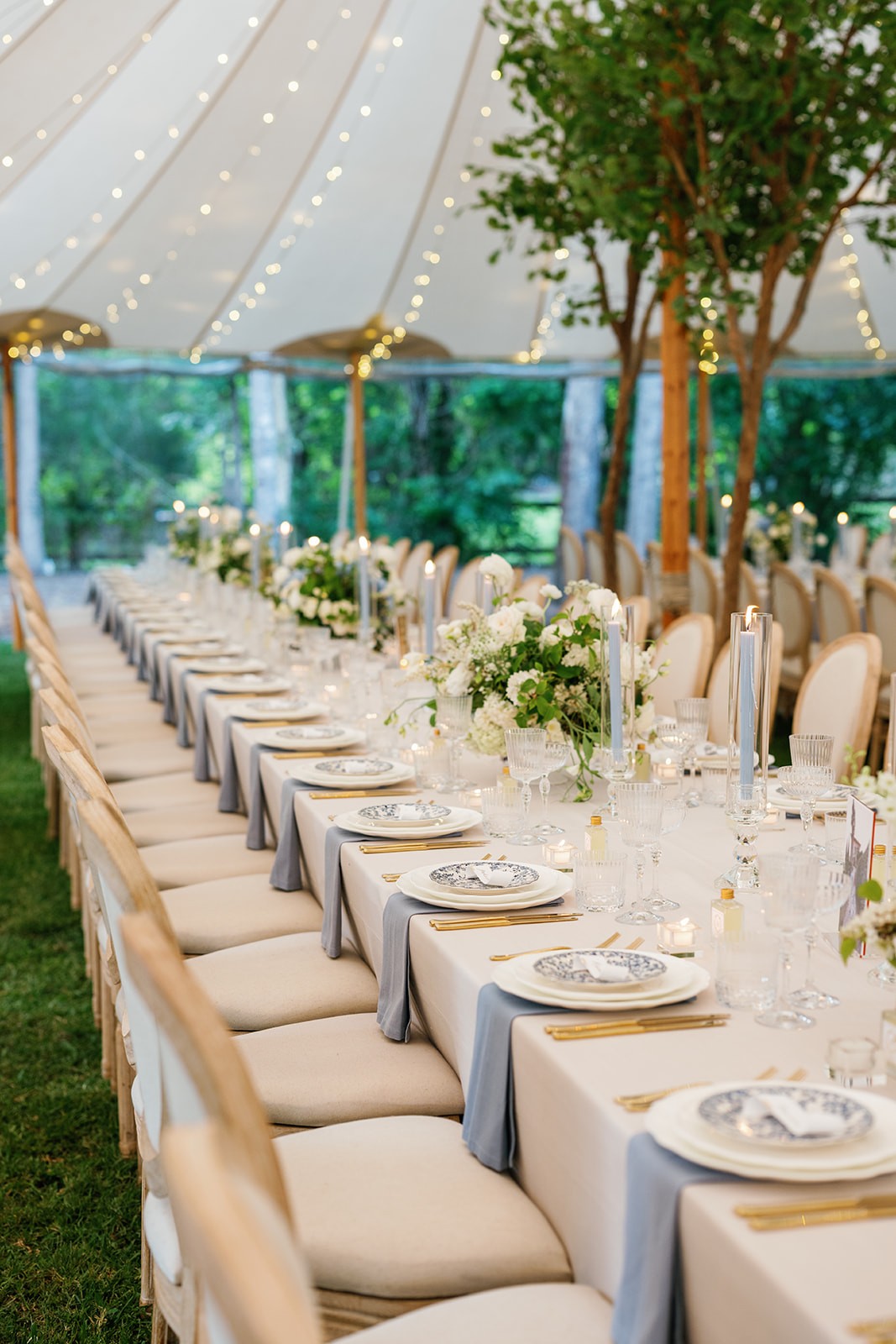 Wedding table setting under an outdoor marquee