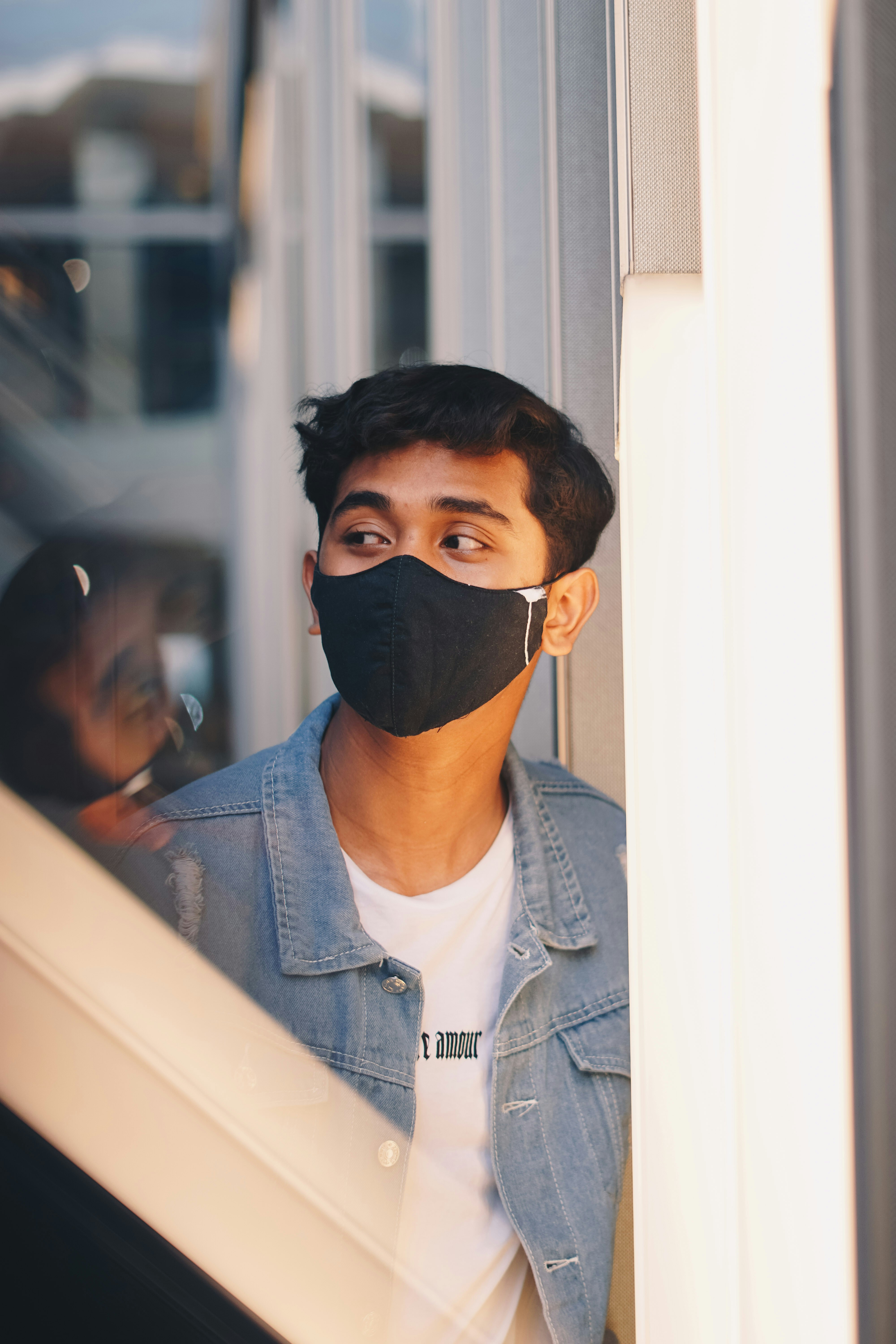 man in blue denim jacket wearing black knit cap