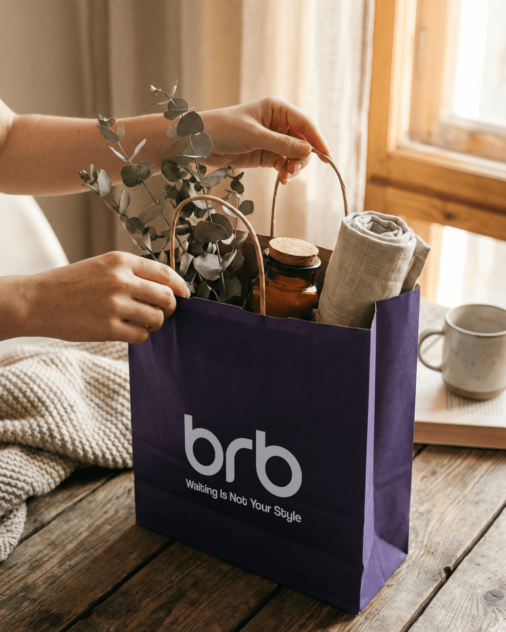 Hands opening a purple BRB bag on a table at home, with flowers and lifestyle items visible inside.