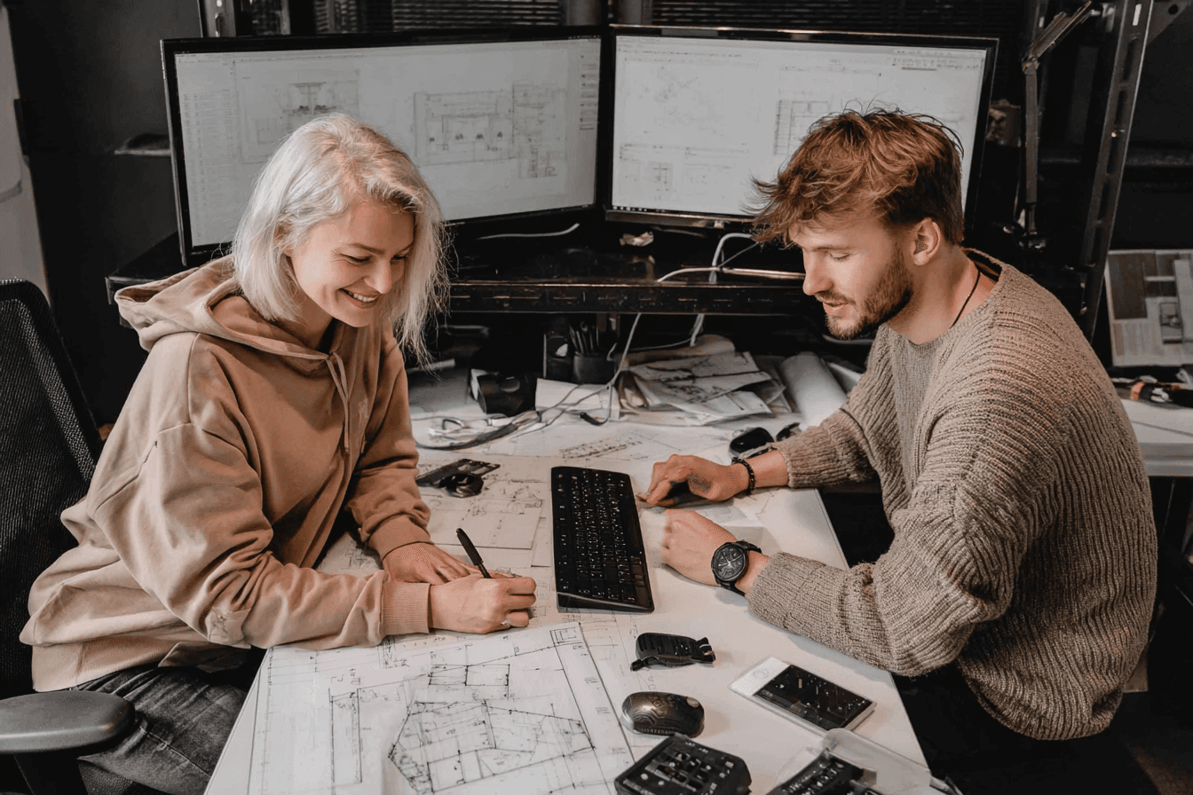 designers at desk talking