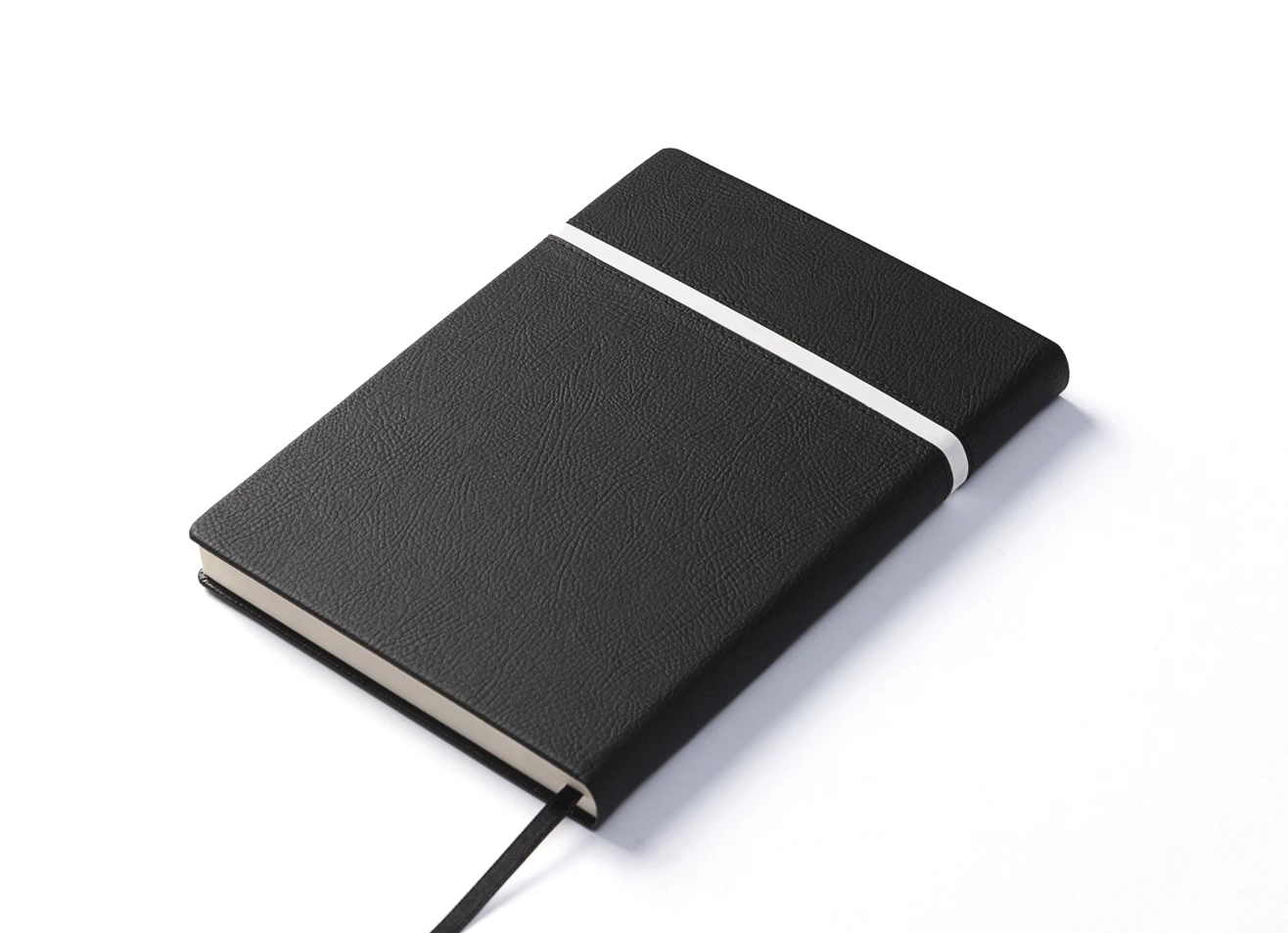 Back angled view of closed black notebook.