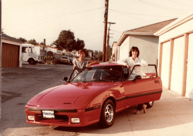 Old photo of the author's family with a car