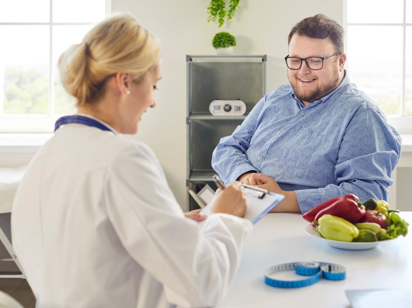 overweight man meeting with a dietitian for complementary support for her shot for weight loss and diabetes