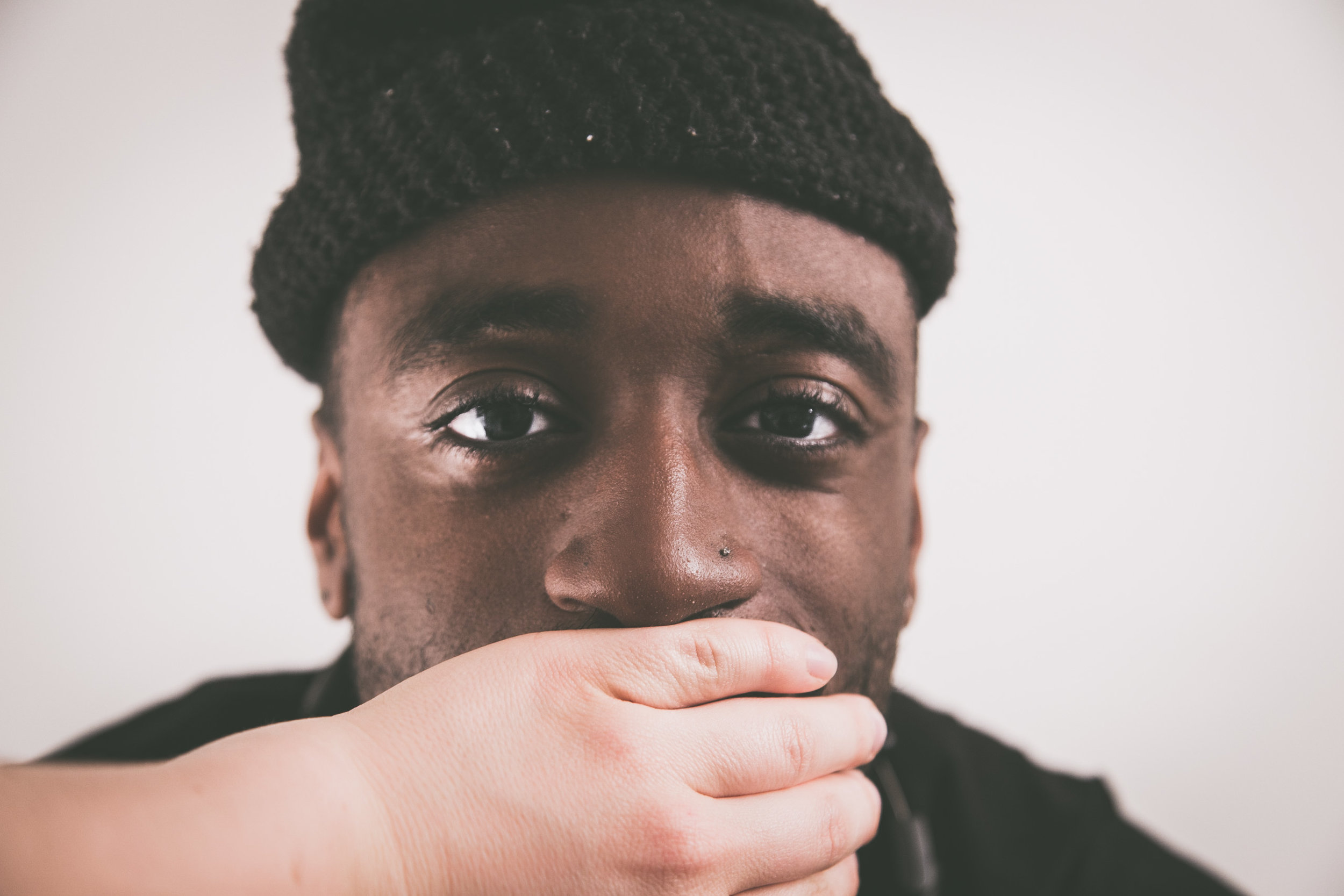 Man with someone covering his mouth