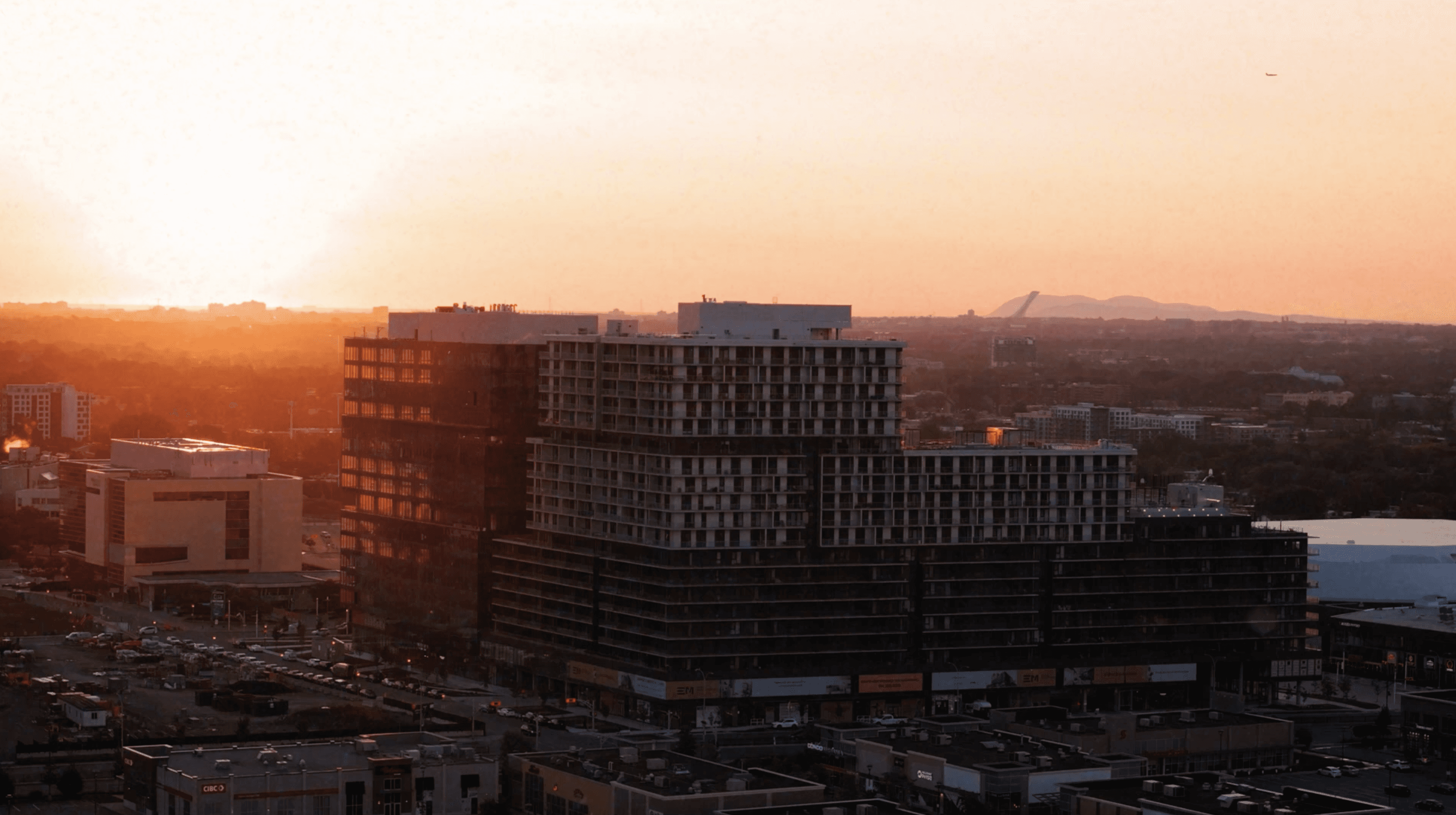 aerial view of a building in the city at sunset