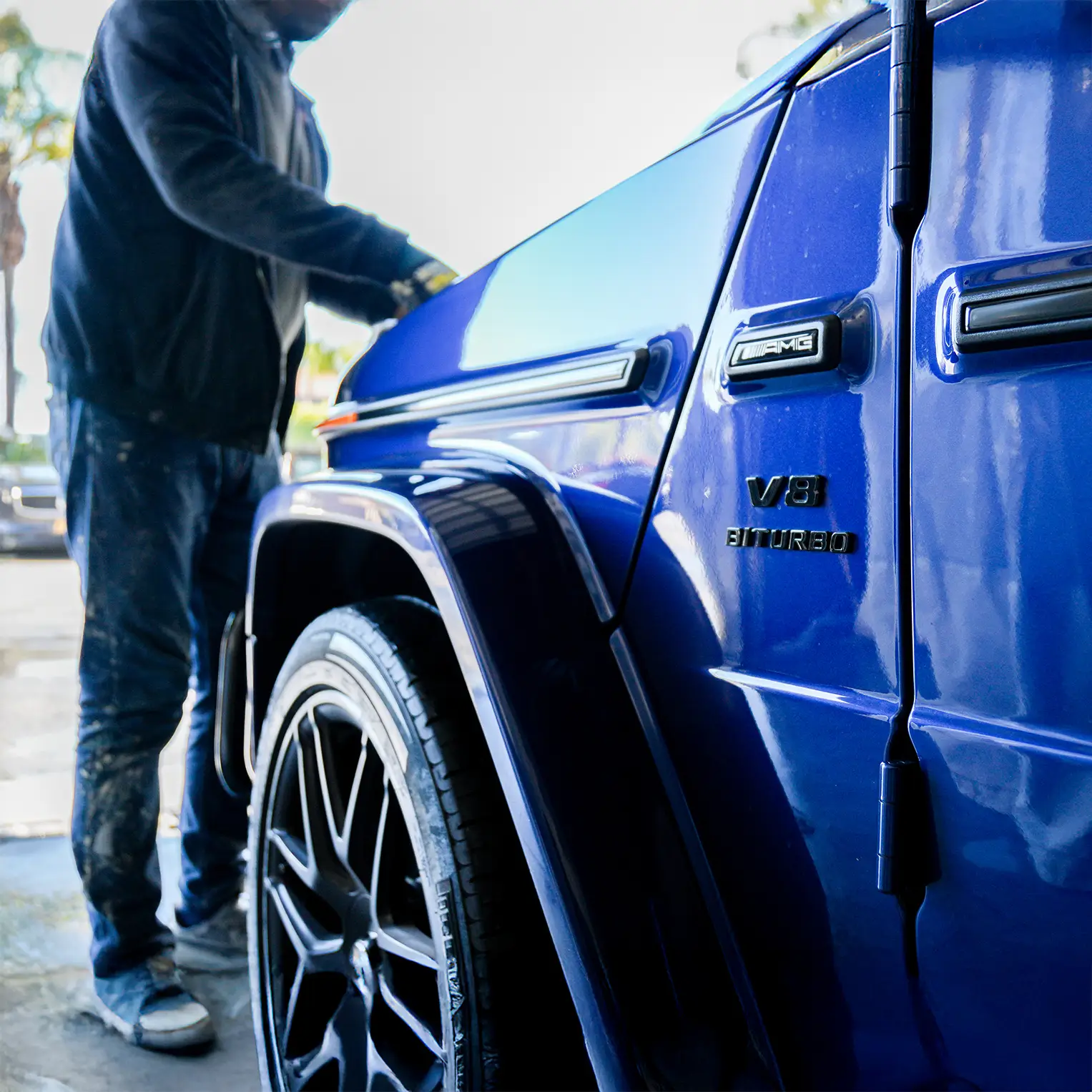 Auto body shop technician inspecting a Mercedes G-Class during an insurance claim repair at Auto Body Unlimited.